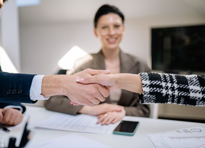 Business partners shaking hands over a new company registration