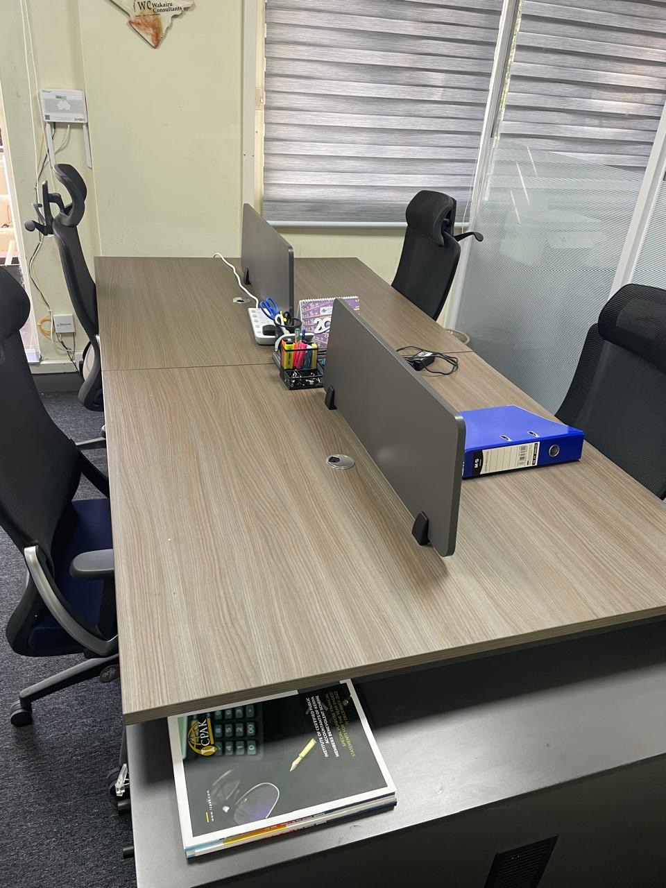 The Wakairu Consultants office with an ICPAK members handbook on the desk